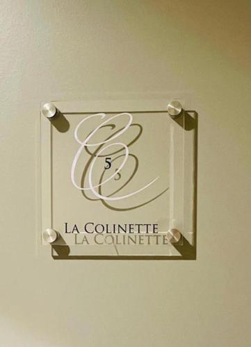 a sign for a la colomite la colomité on a wall at Au Coeur Des Bulles in Loches-sur-Ource