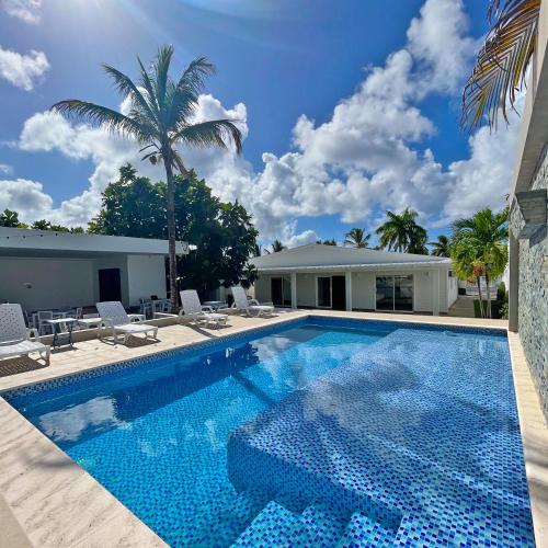 a swimming pool with chairs and a house at Zaba Beach House in San Andrés