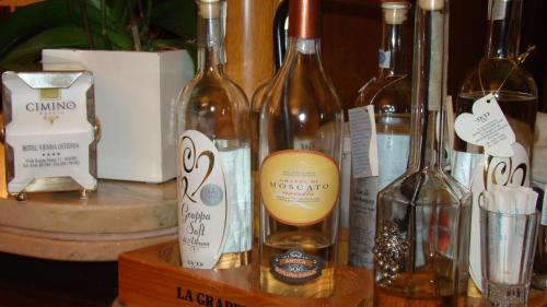 a group of wine bottles sitting on a table at Hotel Vienna Ostenda e Ristorante il Danubio in Rimini