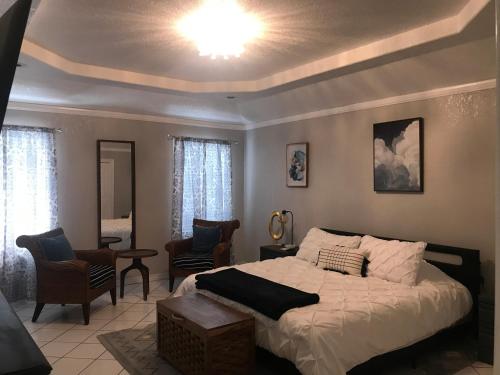 a bedroom with a bed and a living room at Cheerful 4 bedroom home with pool and BBQ area with 5th bedroom option in Brownsville