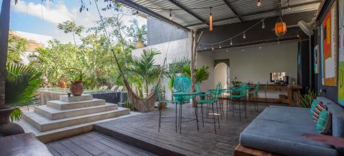 a patio with green chairs and tables and stairs at Turquoise Tulum Hotel in Tulum