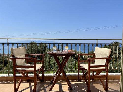 a table and two chairs on a balcony at Villa Marianna in Lourdhata