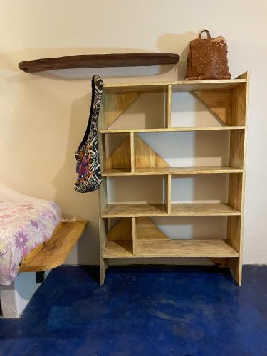 a book shelf in a room with a purse at Hostel Moreré in Moreré