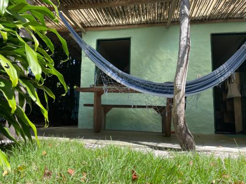 a hammock in front of a house at Hostel Moreré in Moreré
