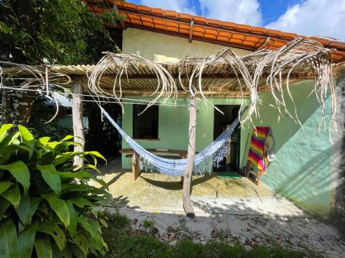 a hammock in front of a house at Hostel Moreré in Moreré