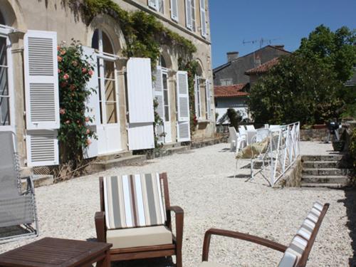 - un groupe de chaises et de tables dans une cour dans l'établissement Chambre d'hotes La maison de Maître, à Fontenay-le-Comte