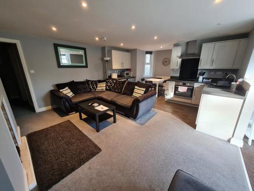 a living room with a couch and a table at Kimberley House in Whitby