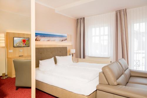 Ένα ή περισσότερα κρεβάτια σε δωμάτιο στο Garni Eden Hotels