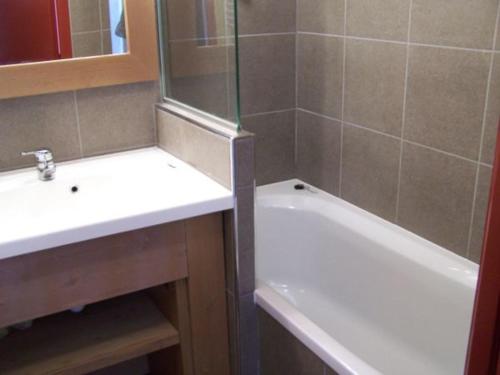 une salle de bain avec un lavabo, une baignoire et un miroir dans l'établissement Appartement confortable pour 8 pers., proche remontées mécaniques, 3 chambres, 3 balcons - FR-1-634-2, à Morzine
