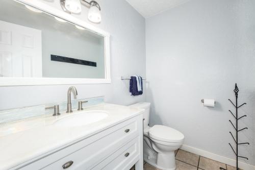 a white bathroom with a sink and a toilet at Cozy Crystal Mountain Condo in Girdwood