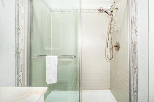 a bathroom with a shower with a glass door at Cozy Crystal Mountain Condo in Girdwood