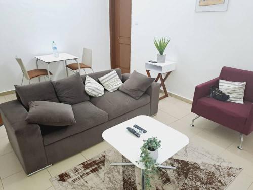 a living room with a couch and a table at PARADISE FB in Cotonou