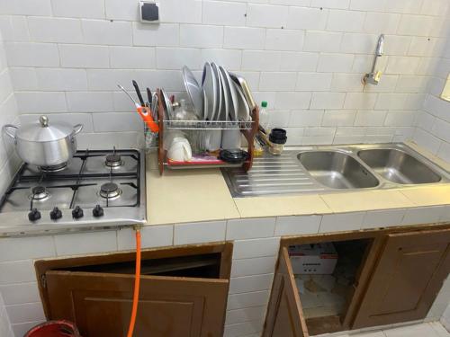 a kitchen counter top with a sink and a counter top at PARADISE FB in Cotonou