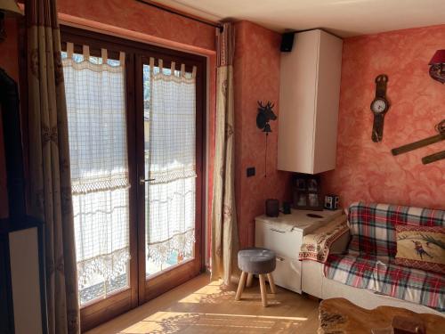 a room with a bedroom with a bed and a window at Appartamento montano in La Thuile