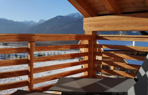 a wooden balcony with a view of the mountains at Kessler's Mountain Lodge in Natz-Schabs