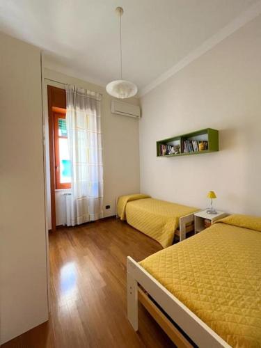 a bedroom with two beds and a window at La Casa sul Corso in Agropoli