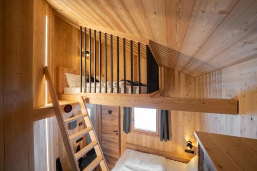 a tree house with a spiral staircase in the middle at Chalet Silvesterhütte in Seiser Alm 