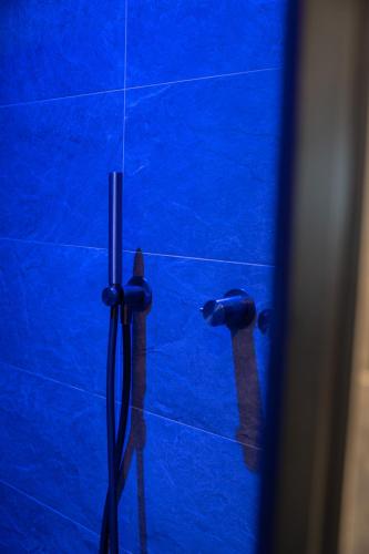 a blue tiled bathroom with a blue shower stall at Chalet Silvesterhütte in Seiser Alm 