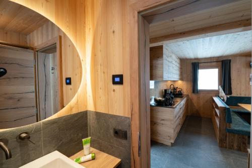 a bathroom with a sink in a wooden cabin at Chalet Silvesterhütte in Seiser Alm