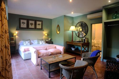 a living room with a bed and a table at Hotel Boutique Pinar in Cuenca