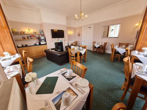 a dining room with tables and chairs in a restaurant at Kimberley House in Whitby