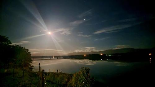 a view of a river at night with a bridge at Codroy Valley Cottage Country in Doyles