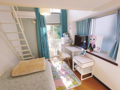 a small room with a desk and a computer and a room with a ladder at Glen Stage 102 - Vacation STAY 13962 in Saitama