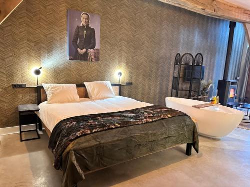 a bedroom with a large bed and a bath tub at Landgoed Lodges Scholten Linde in Rossum