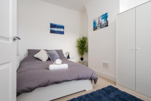 a bedroom with a bed and a blue rug at DENEBANK LODGE - Strictly NO Parties in Liverpool