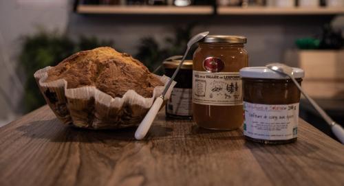 a loaf of bread and a jar of honey on a table at Gite Auberge Les Cascades in La Mongie