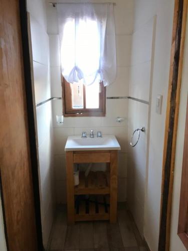 a small bathroom with a sink and a window at FINCA LA PAZ in Uspallata