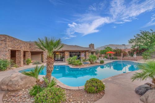 a house with a swimming pool in a yard at Coral Springs Resort H2 Brand New Home, Community Pool, Outdoor Fireplace, and Near Sand Hollow in Washington