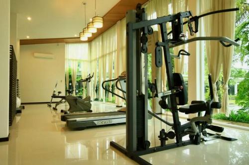 a gym with cardio equipment in a room at White Lotus by Oxygen at Bang Tao Beach in Ban Thalat Choeng Thale