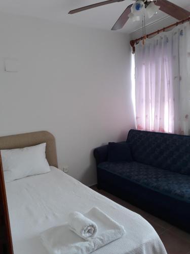 a bedroom with a bed and a couch at Villa Asel in Dalyan