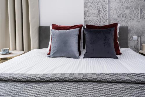 a bed with two pillows and a white bedsheet at Sol Marina Resort Wyspa Sobieszewska I - LoftAffair Collection in Wiślinka