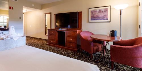 a hotel room with a bed and a television and a table at Wendover Nugget Hotel & Casino by Red Lion Hotels in West Wendover