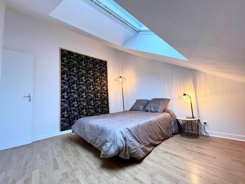 um quarto com uma cama e dois candeeiros em Appartement T3 cœur de Dinan em Dinan