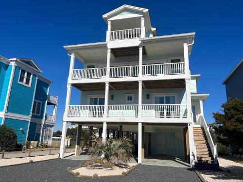 a large white building with a balcony at 1030 Ocean home in Holden Beach