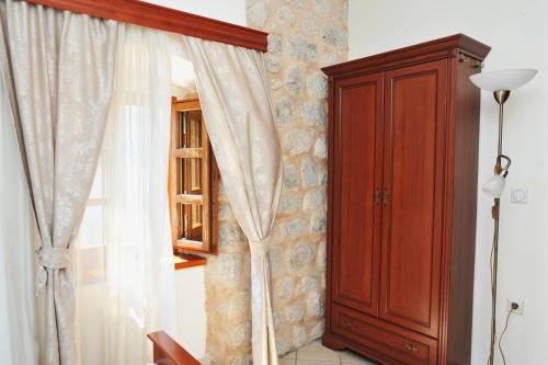 a room with a window and a wooden cabinet at Lady of the Rocks apartments in Perast