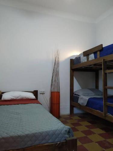 a bedroom with two bunk beds and a checkered floor at Finca La Codiciada in San Rafael