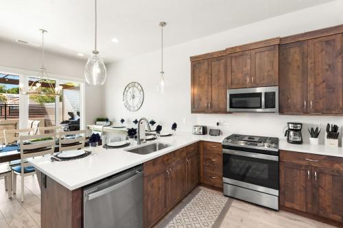 a kitchen with wooden cabinets and stainless steel appliances at Ocotillo Springs Resort 45 l Brand New Property, Private Pool, Hot Tub, & Community Pool in Santa Clara