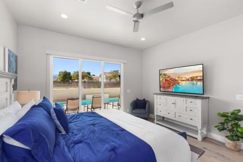 a bedroom with a large bed and a flat screen tv at Ocotillo Springs Resort 45 l Brand New Property, Private Pool, Hot Tub, & Community Pool in Santa Clara