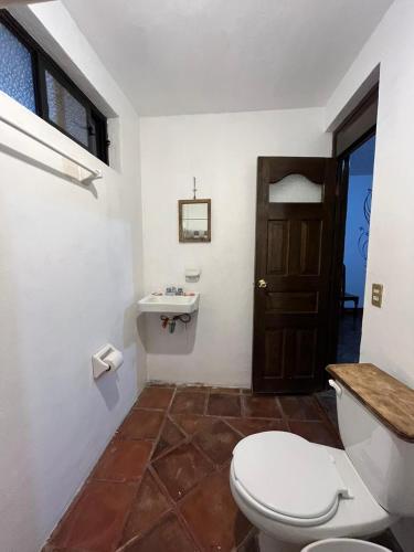 a bathroom with a toilet and a sink at GRUPO MARMIL in San Juan