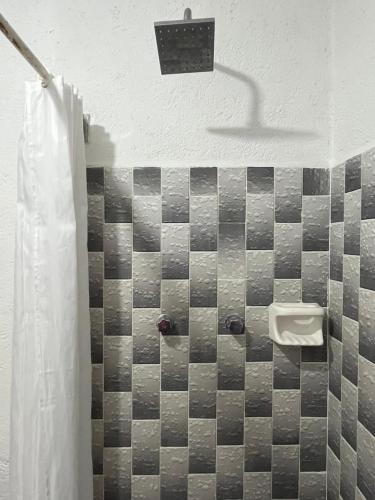 a bathroom with a sink and a urinal on the wall at GRUPO MARMIL in San Juan