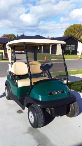 a golf cart parked in a parking lot at Omokoroa Golfers Retreat - B&B in Omokoroa