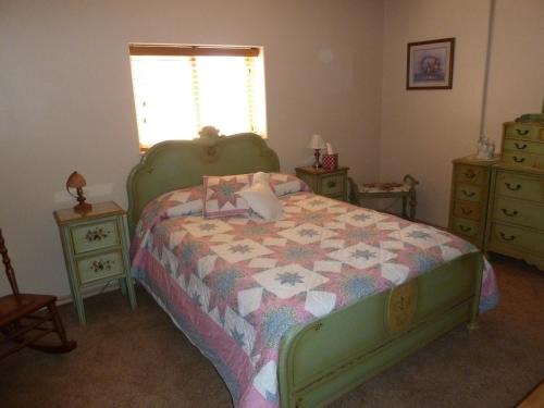 a bedroom with a bed with a quilt on it at Red Rock Hacienda in Kanab