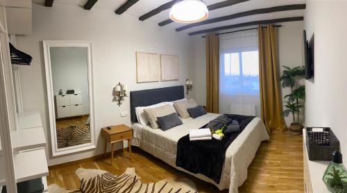 a bedroom with a large bed and a large window at La Pastora Apartamento con parking in Gavà