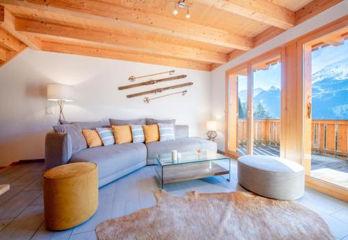 a living room with a couch and a table at Racers Retreat 10 in Wengen