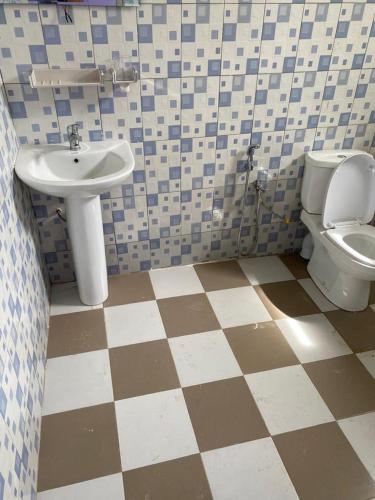 a bathroom with a sink and a toilet at Studio meublé 1 à ouakam Comico Dakar in Dakar