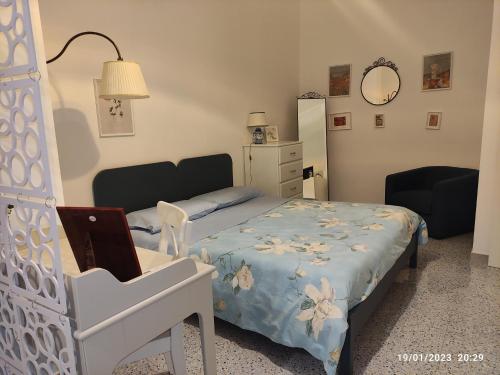 a bedroom with a bed and a desk with a laptop at Casa del Mare Appartamento Bucceri Salvatore in Letojanni